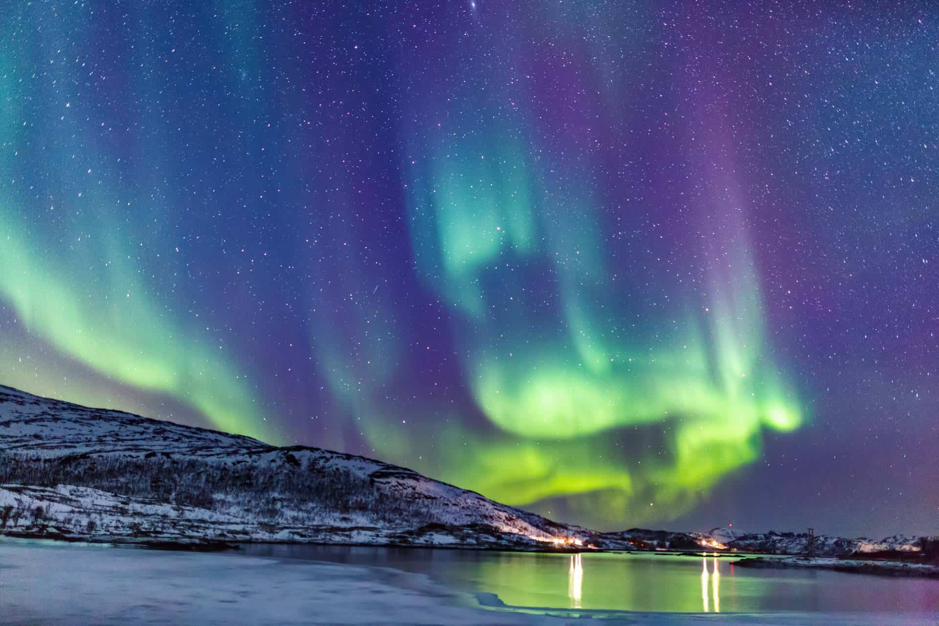 Incredible northern lights (aurora borealis) above the coast in Norway.