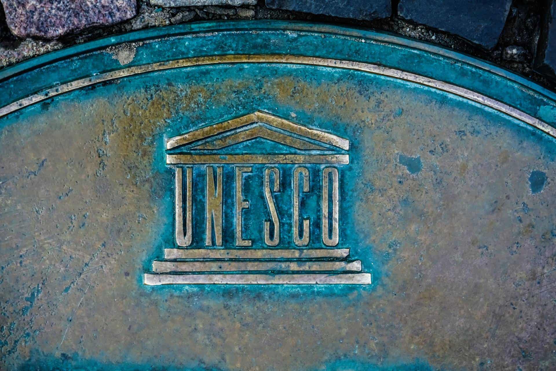 UNESCO logo on copper background.