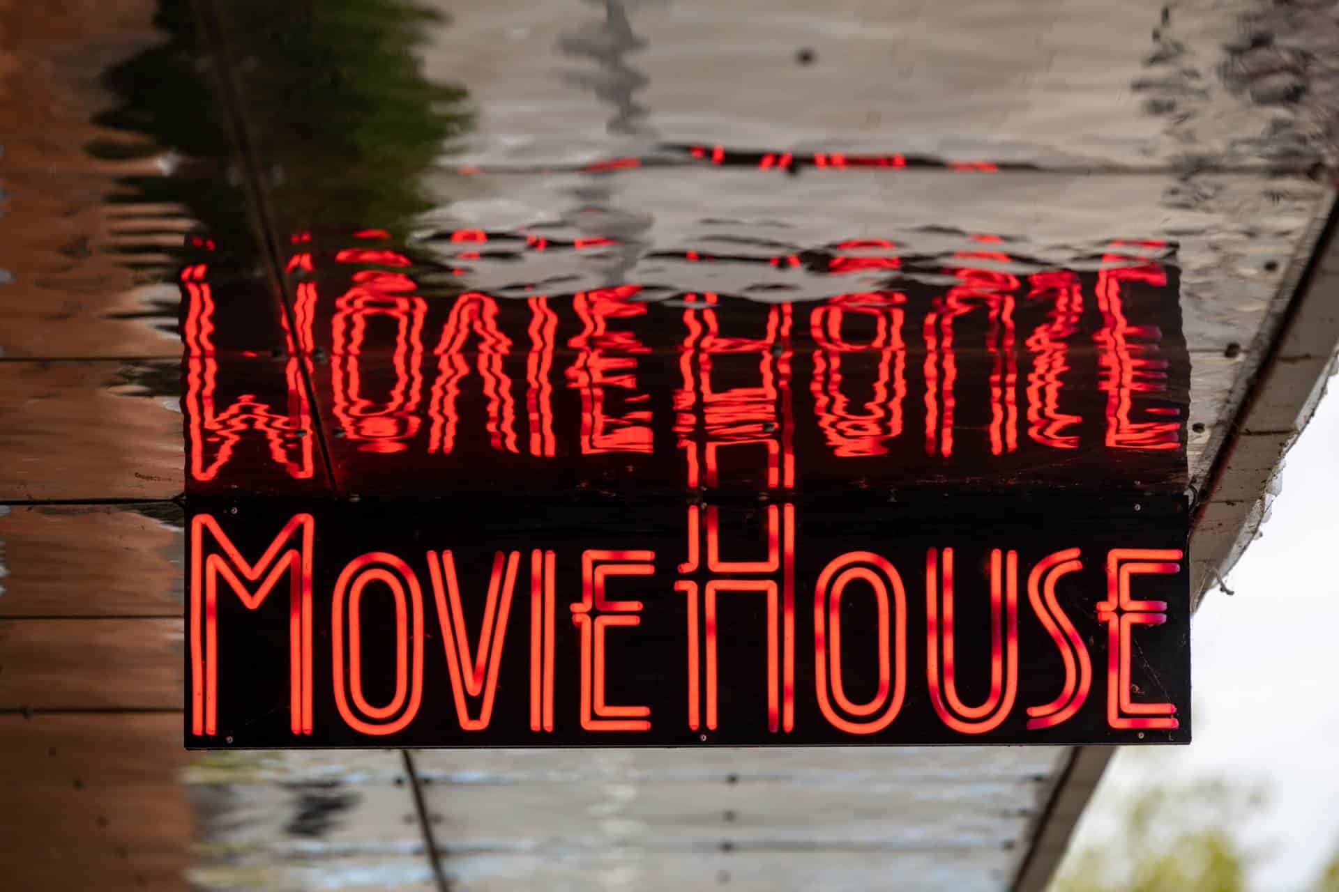 A red neon sign for a movie house or cinema,