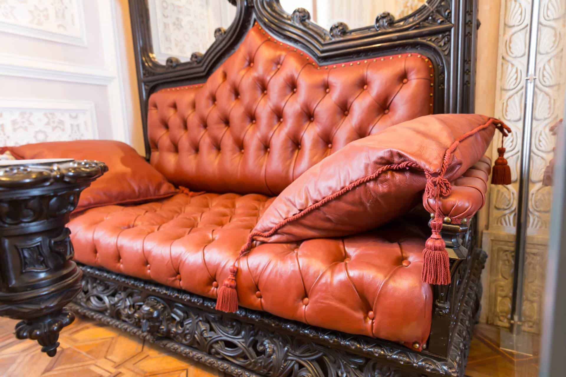 Luxurious, leather-covered sofa with pillows.