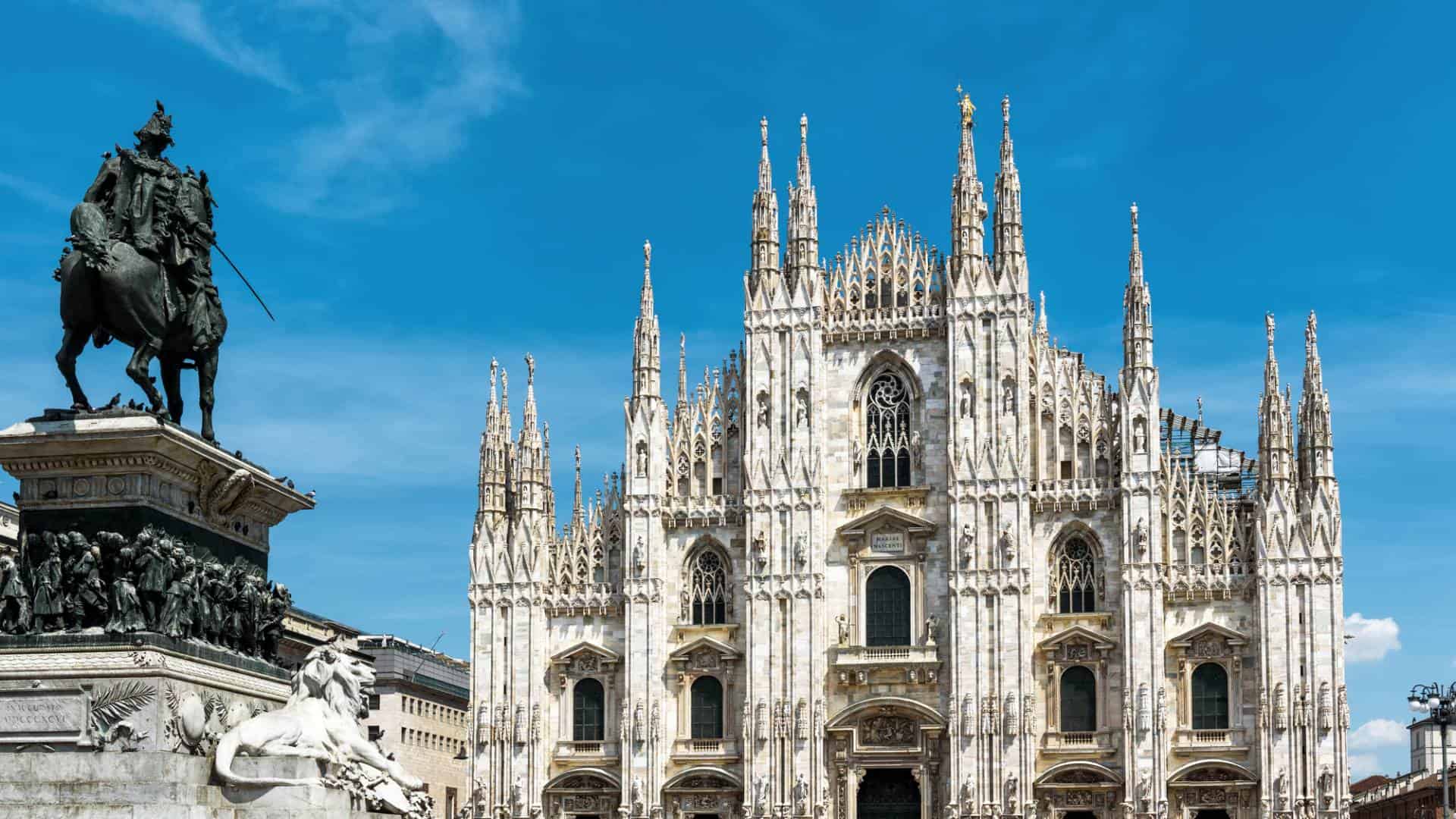The famous Milan Cathedral (Duomo di Milano) and monument to Victor Emmanuel II on Piazza del Duomo in Milan, Italy.