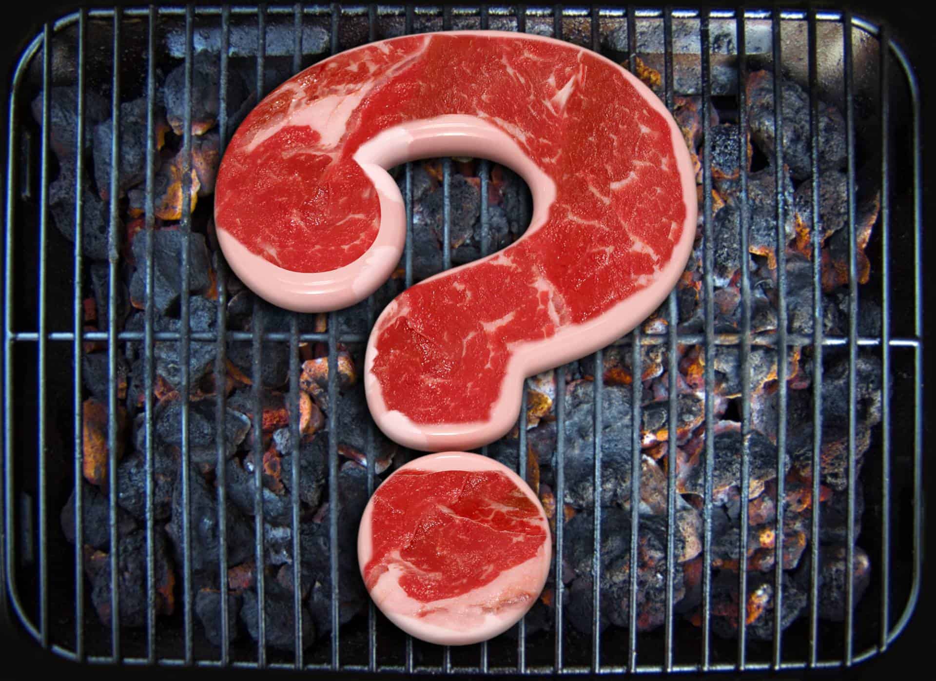 Raw meat on a grill in the shape of a question mark.