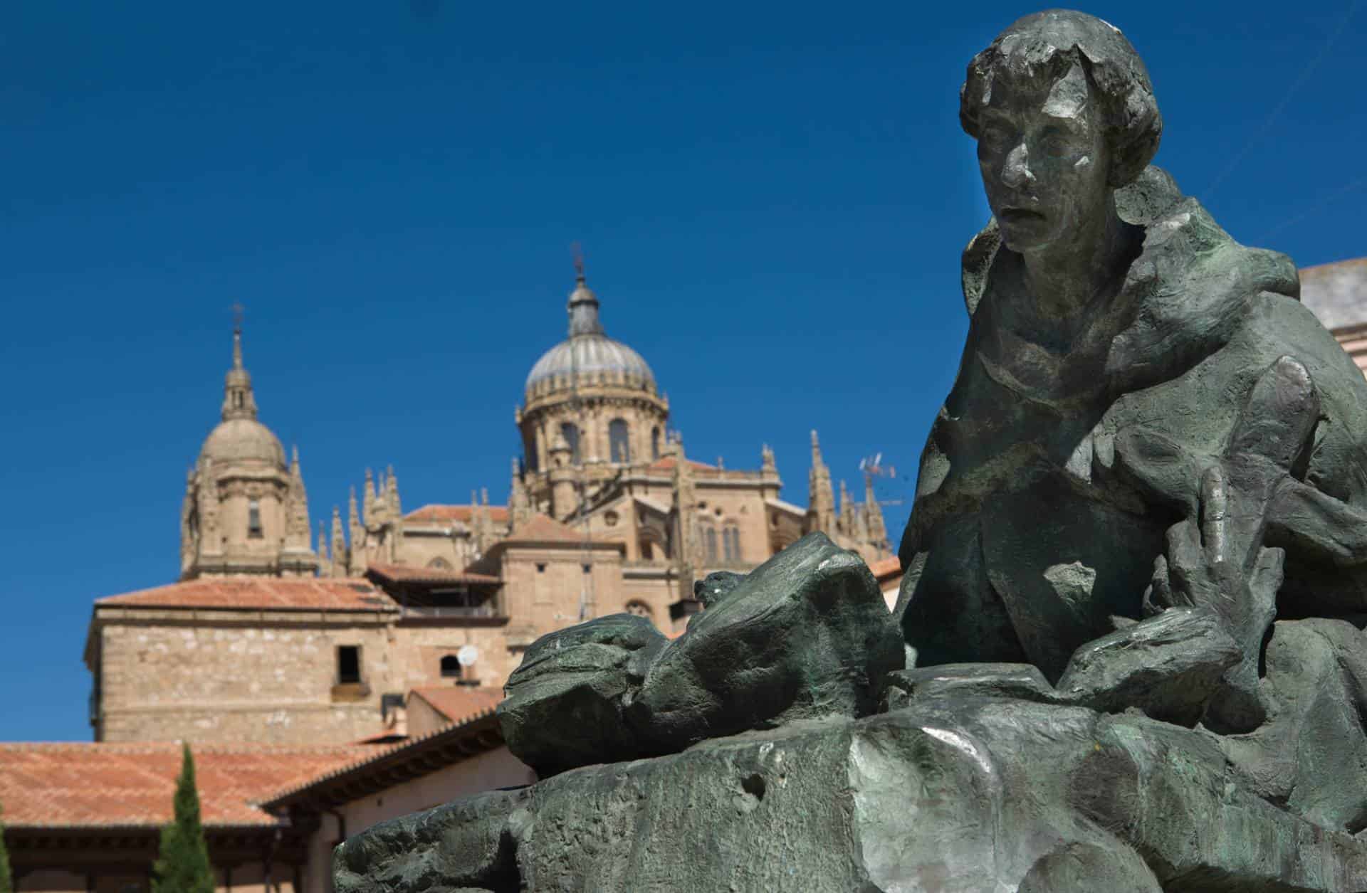 Statue of Saint John of the Cross with Salamanca Cathedral in the background. He was a major figure of the Counter-Reformation in Spain.