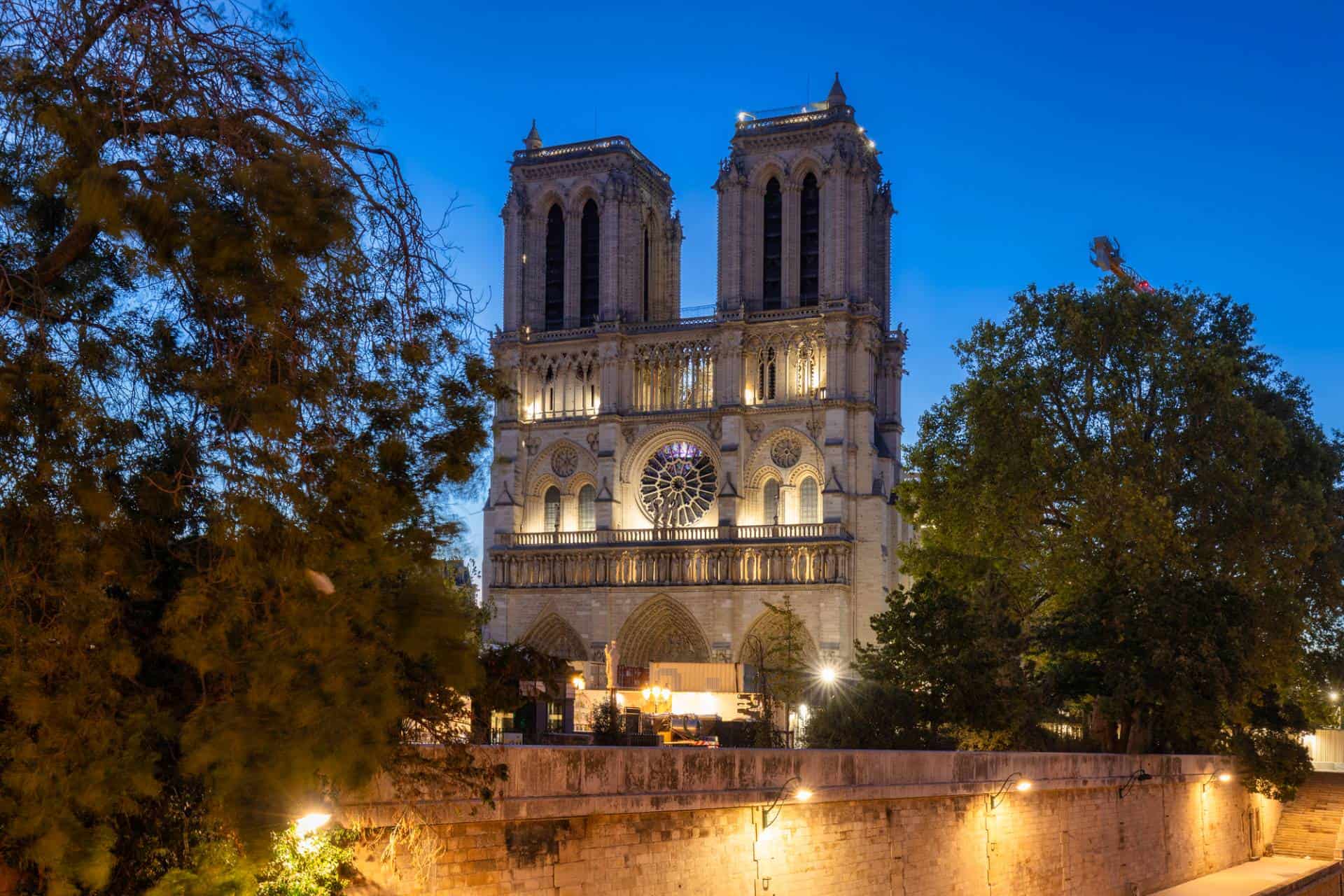 Notre Dame Cathedral, by the Seine River in Paris, France at dawn - the setting of Victor Hugo's novel The Hunchback of Notre Dame.