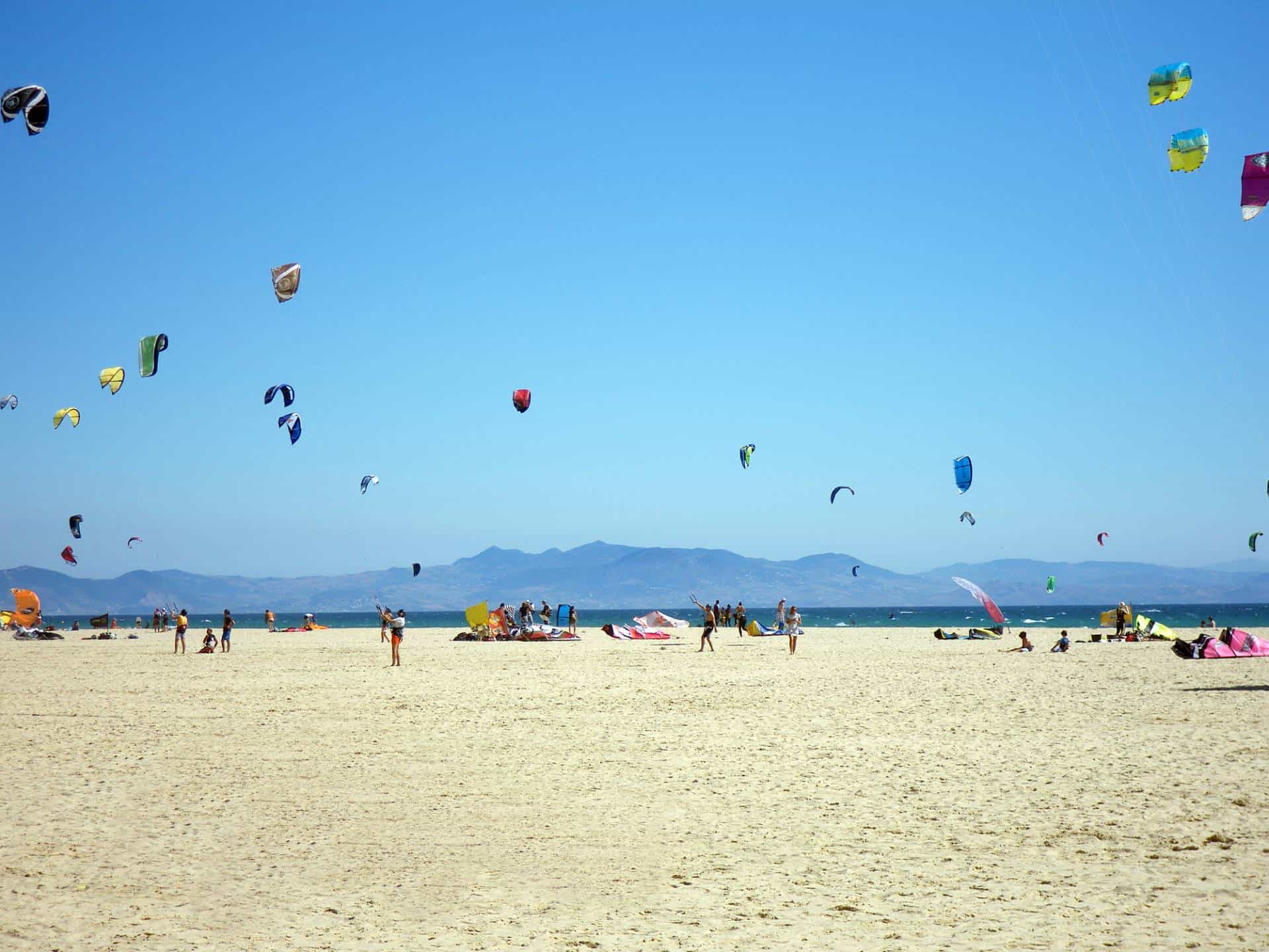 Kitesurfers on the beautiful beach of Tarifa, Spain.