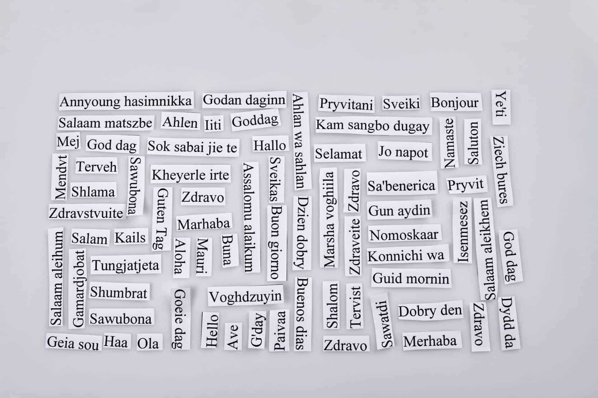 Paper pieces with the word "hello" in many different languages.