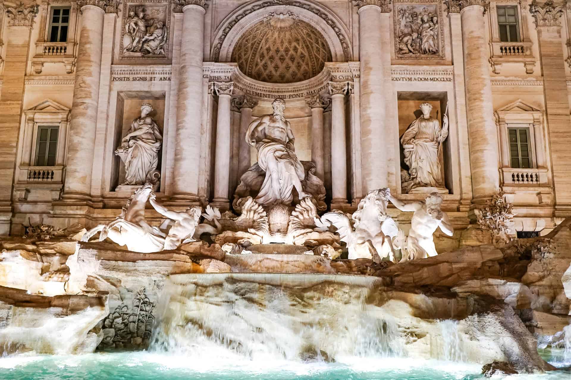 Trevi Fountain in Rome with ancient scriptures near water