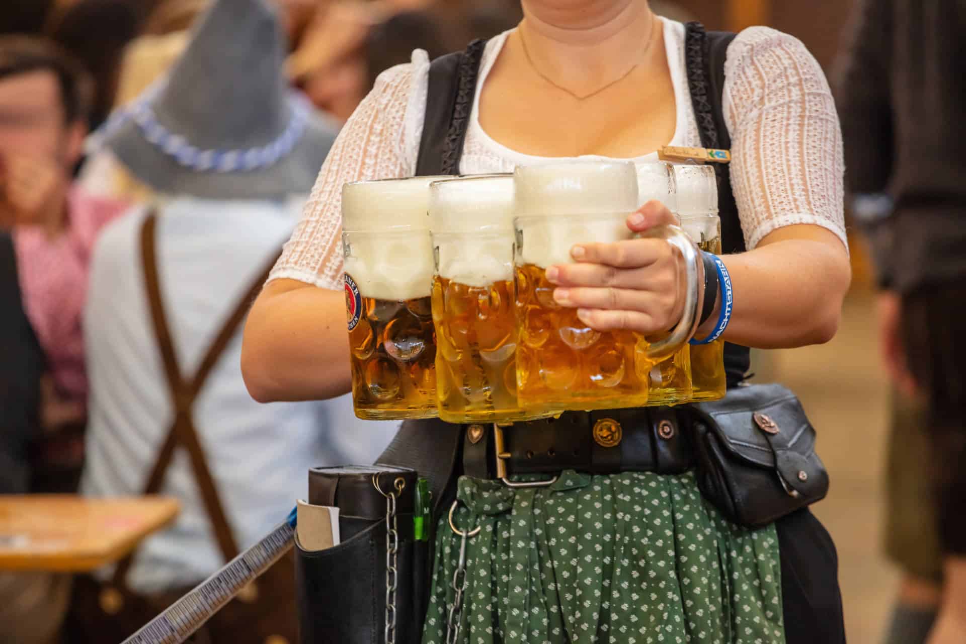Waitress carrying traditional beer mugs at Oktoberfest in Munich, Germany