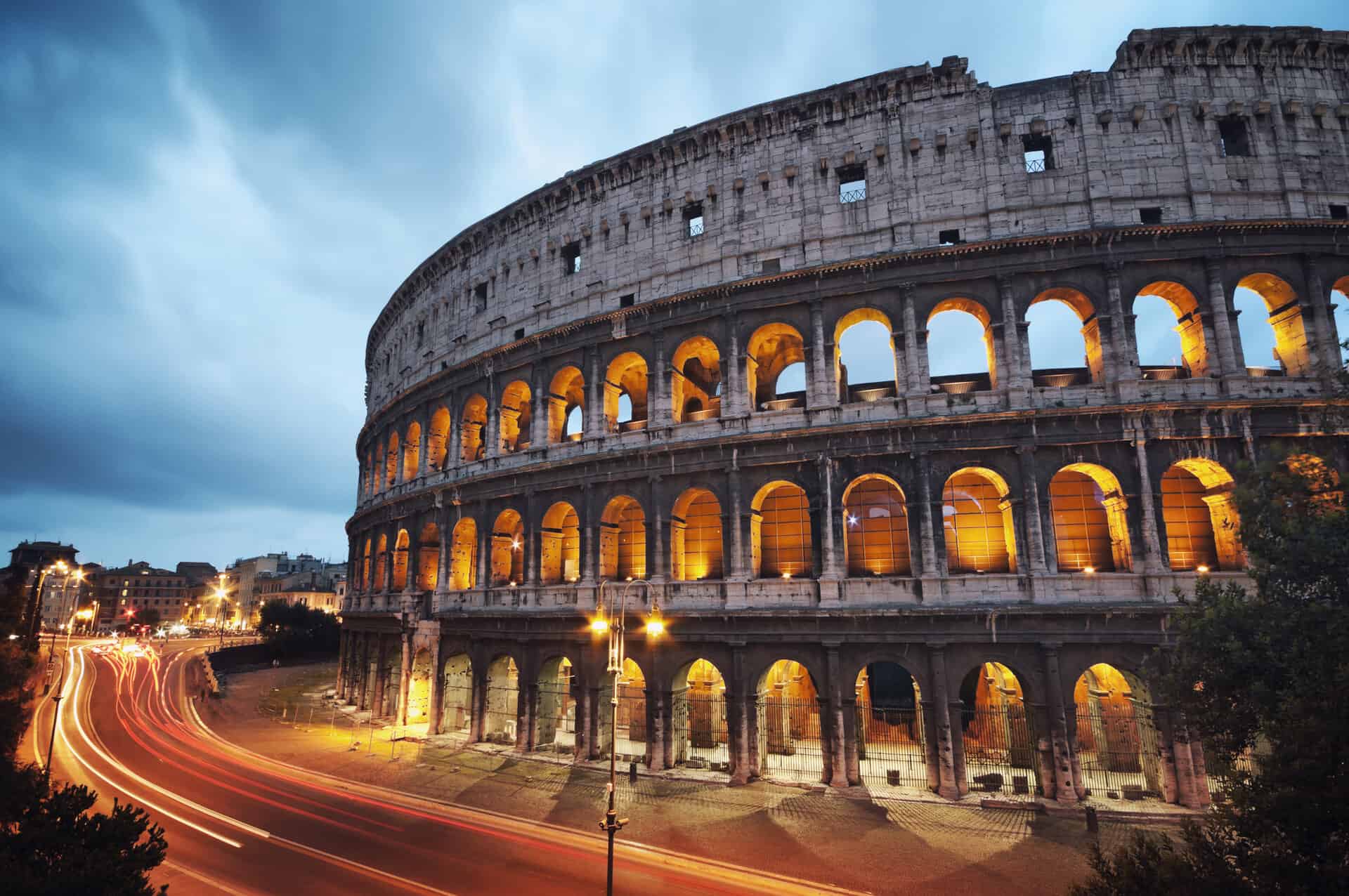 The Coliseum in Rome, Italy with dark skies and bright lighting