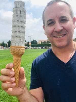 Europe Travel Guide Corry Castaneda holds ice cream cone under Eifel Tower