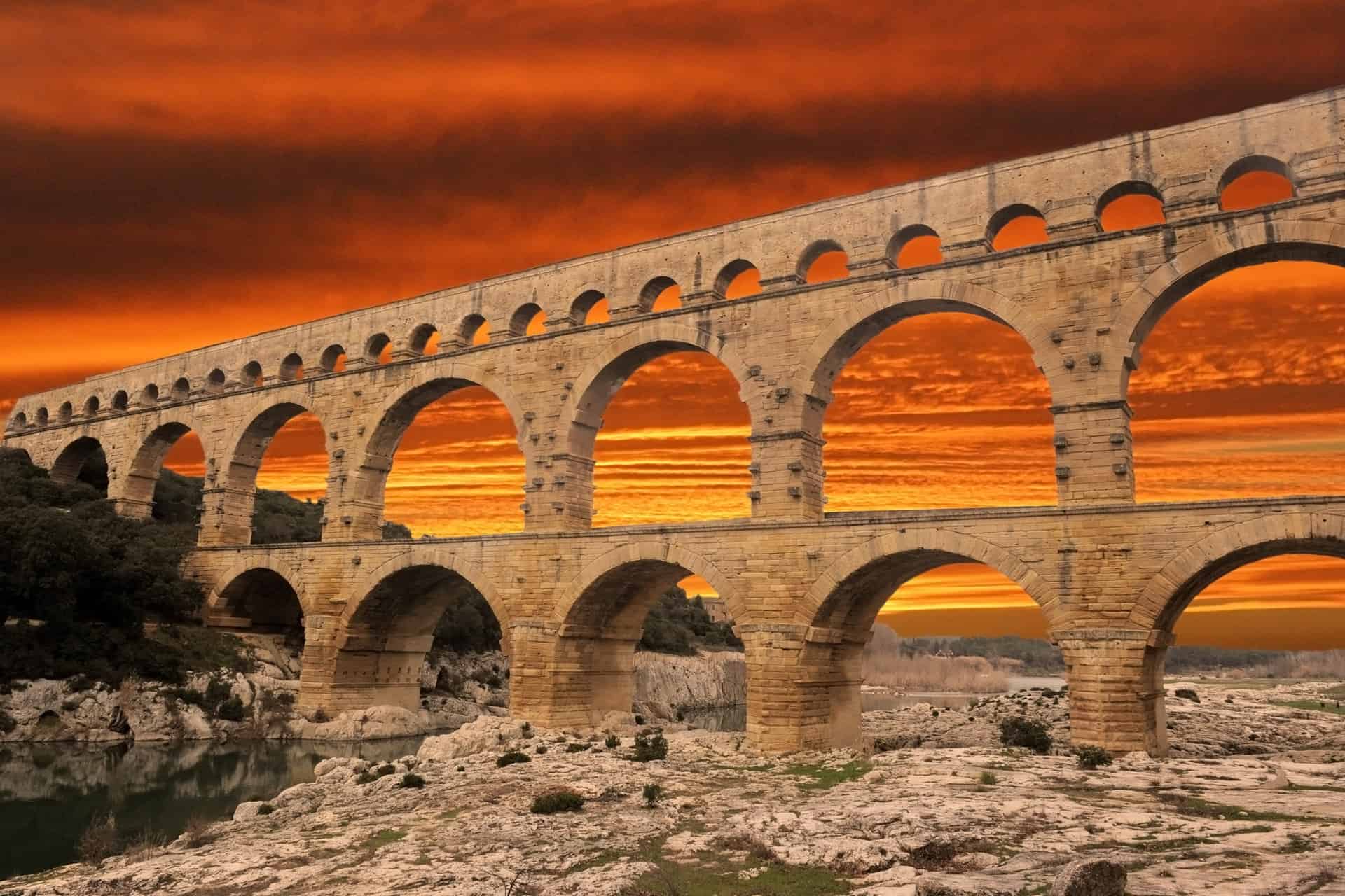 Pont Du Gard with orange sunset in sky